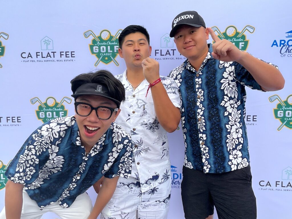 a group of three golfers in Hawaiian shirts