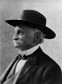 headshot of Lucky Baldwin in a black suit jacket, tie, and hat