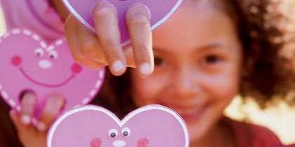 City of Arcadia Kid’s Night Out small child holding up paper hearts