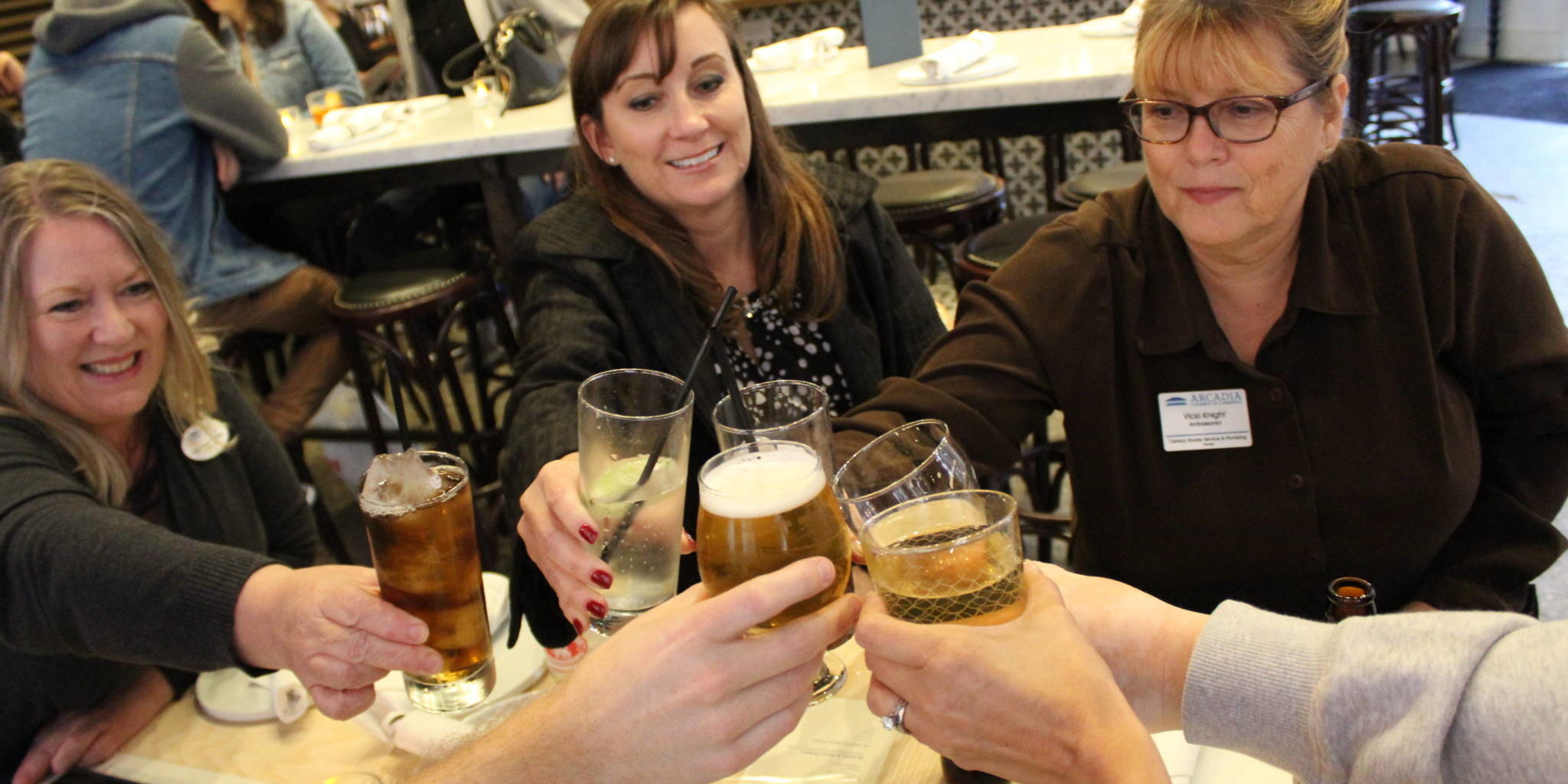 IMG_8461 a group of people cheering with glasses of soda