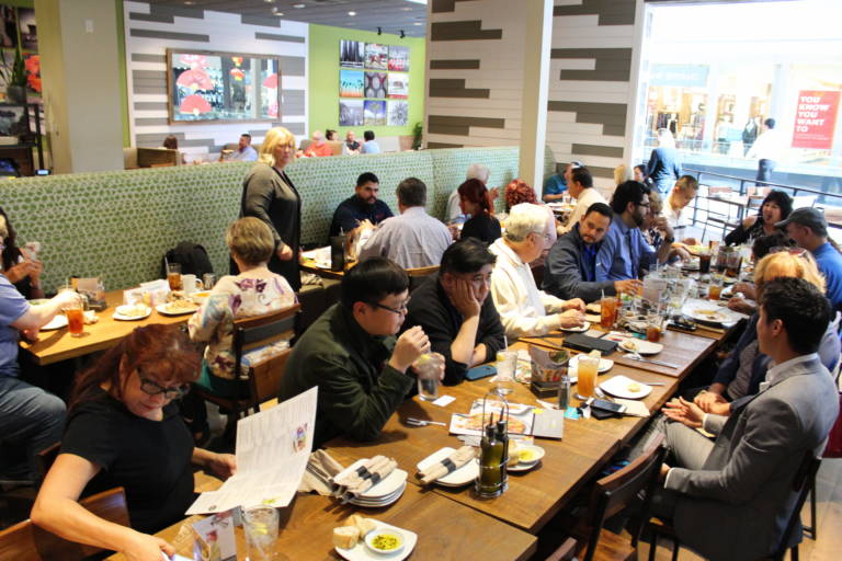 IMG_9308 a long table full of people eating lunch at a restaurant