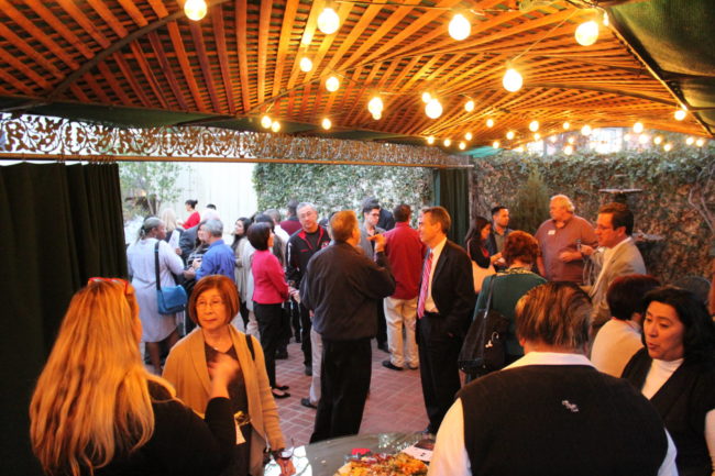 IMG_0963 a gathering of people on a patio under a canopy with lights
