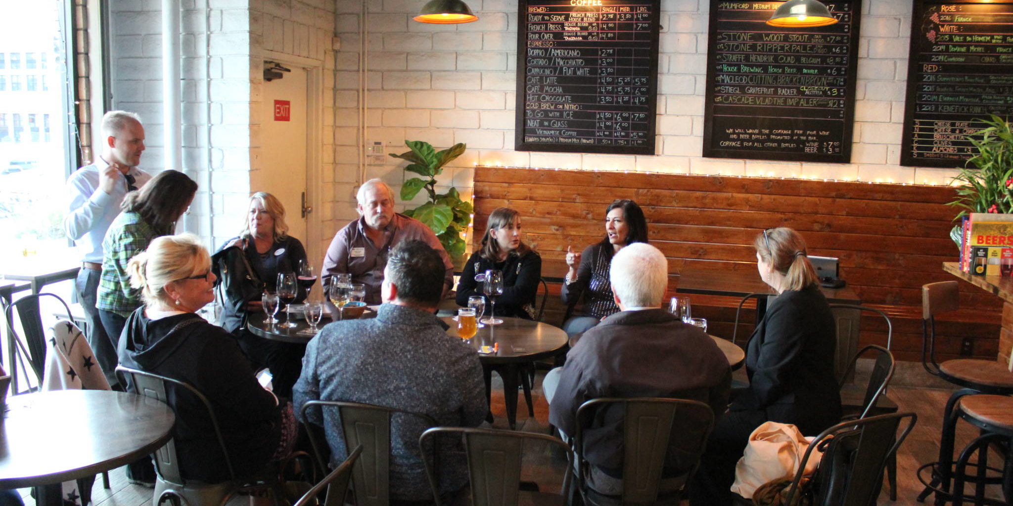 IMG_1491 a group of people sitting in a the round in a wine bar