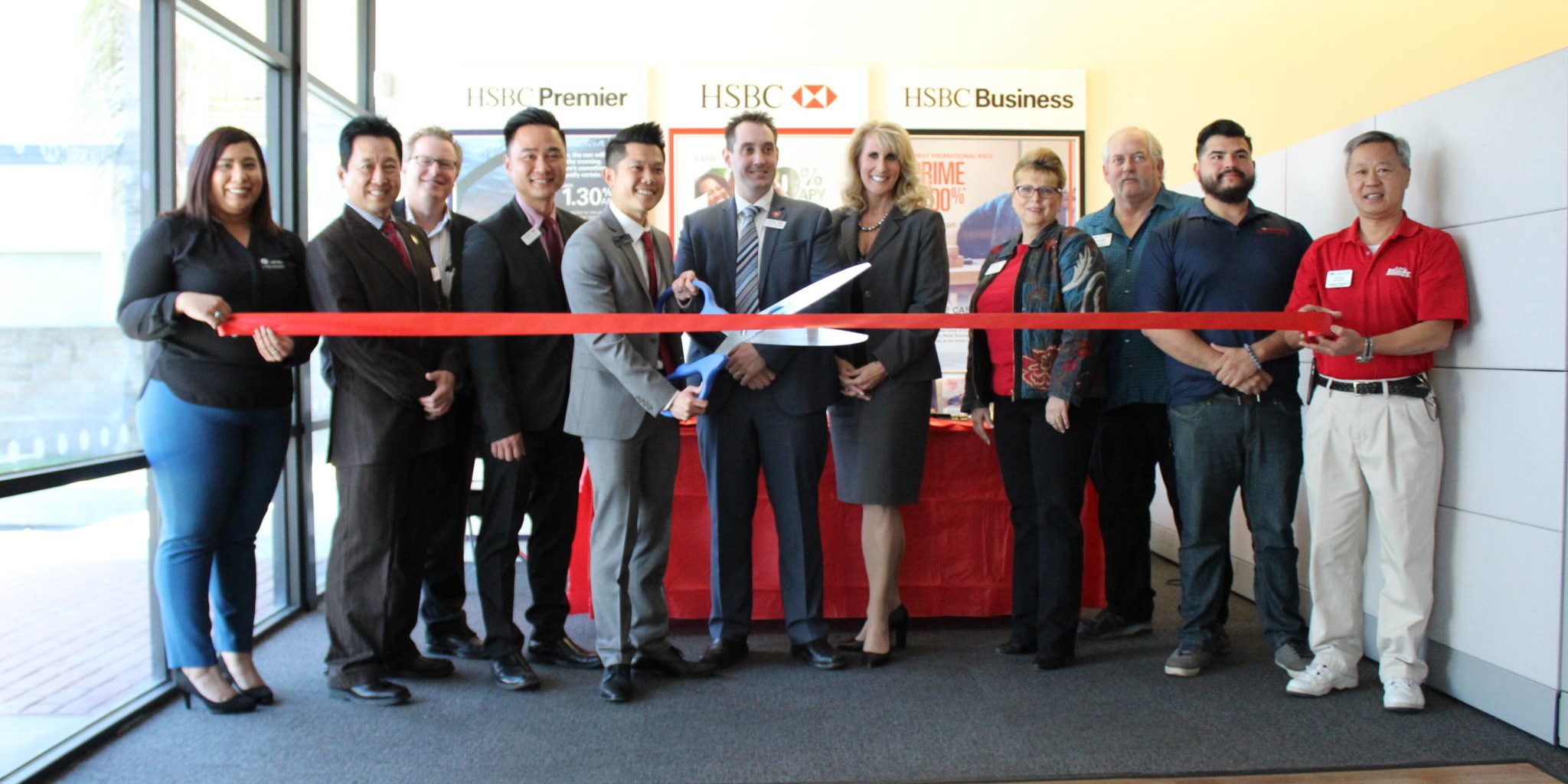 IMG_1784 a group of people in bank getting ready for a ribbon cutting