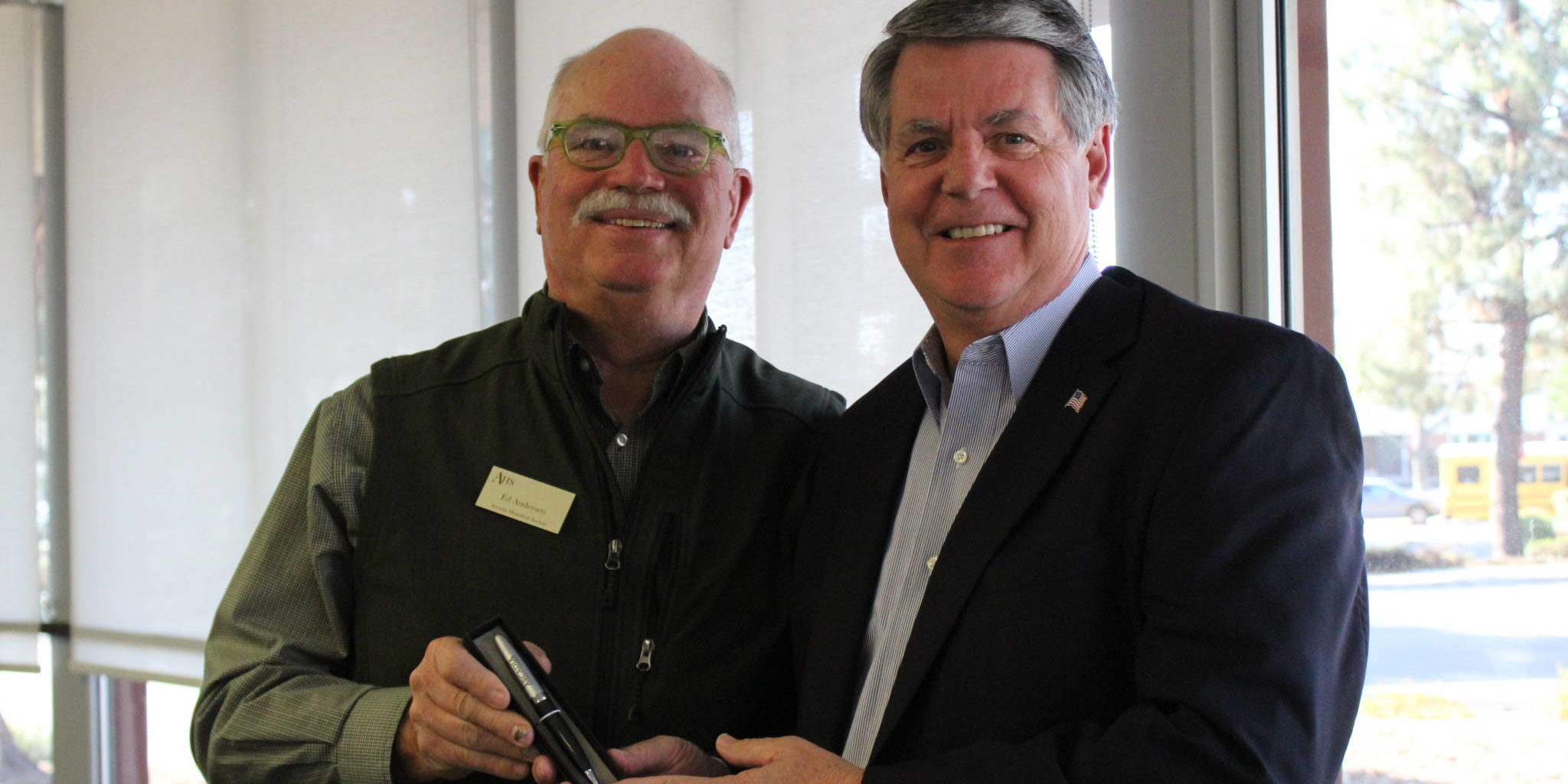 IMG_2000 two men holding a pen