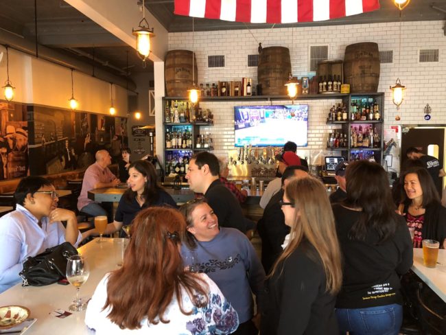 a group of people in a restaurant watching a sports game