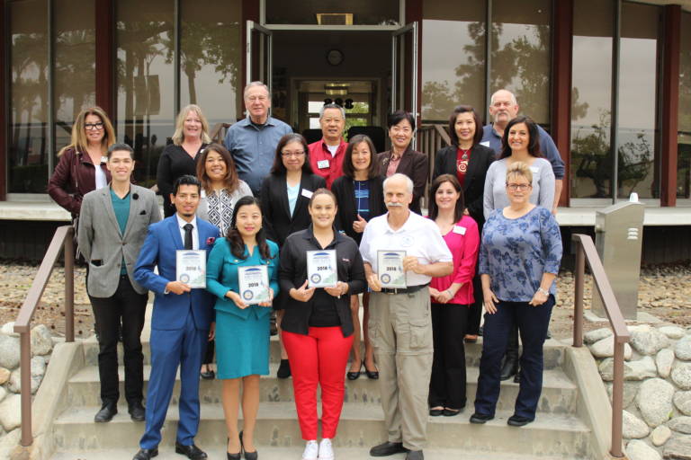 a group of people standing on the back steps of the Arcadia Chamber building