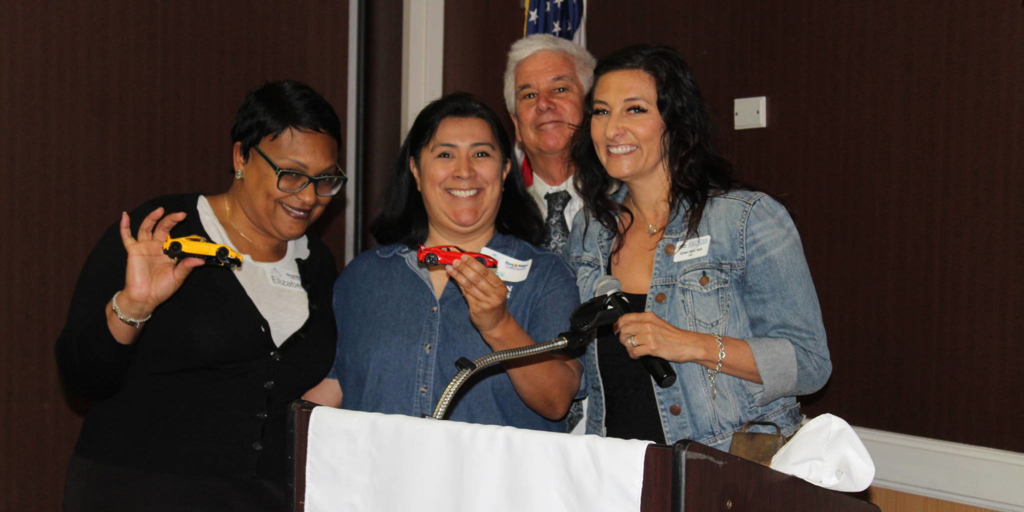 IMG_9417 a group of people being silly while standing behind a podium