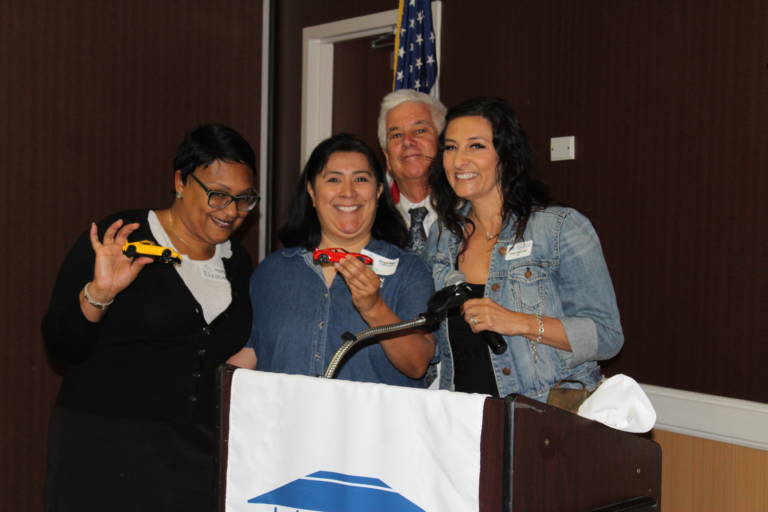 a group of people being silly while standing behind a podium