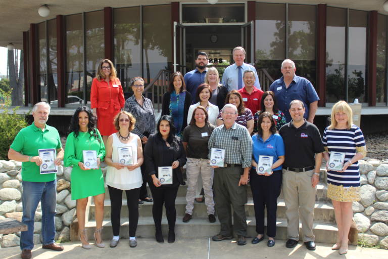 a group of people standing on the back steps of the Arcadia Chamber building