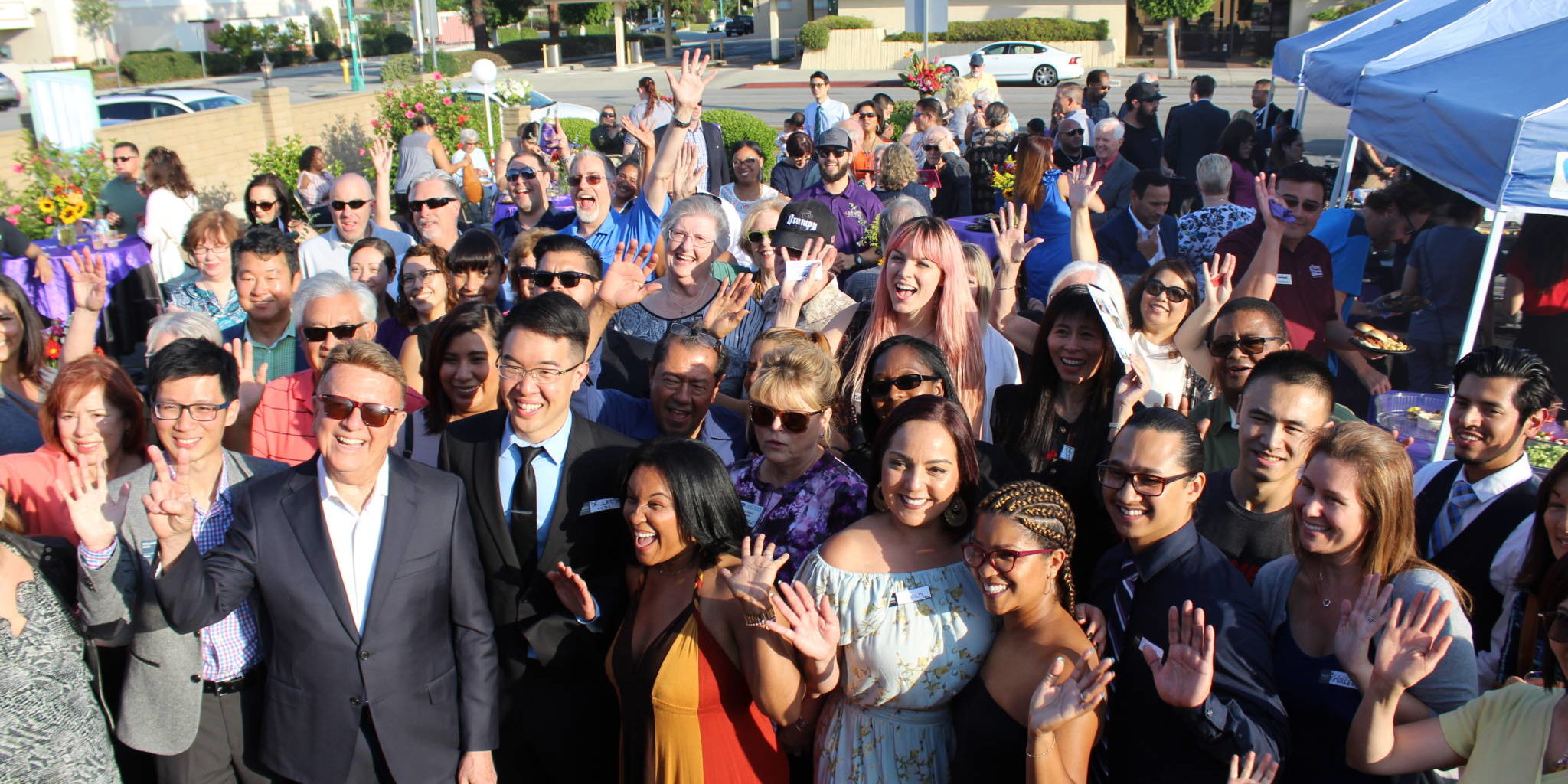 a group of people at a ribbon cutting seen from above