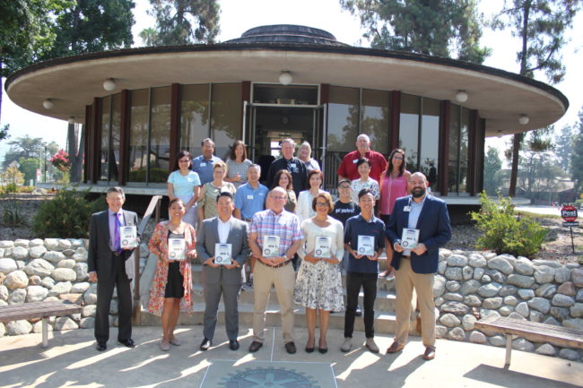 IMG_0031 a group of people standing on the back steps of the Arcadia Chamber building holding plaques