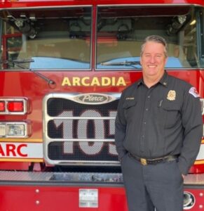 Arcadia Fire Chief Spriggs in front of Fire Truck 105
