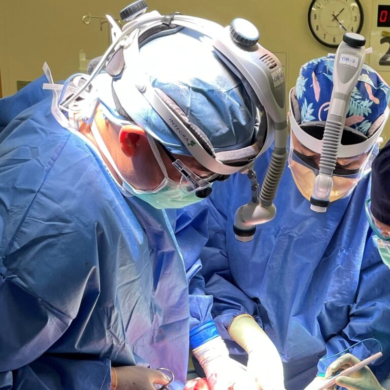 Dr William Tseng of City of Hope performing surgery while wearing blue scrubs