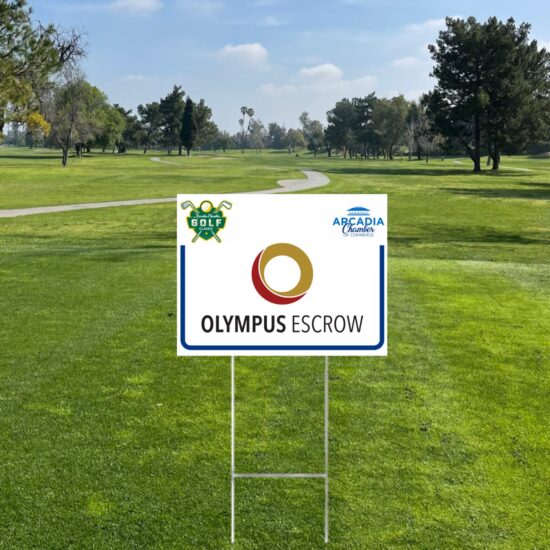 a golf tee sign on a course showing the logo for Olympus Escrow