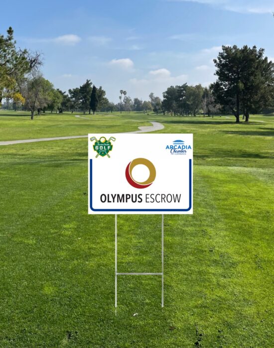 a golf tee sign on a course showing the logo for Olympus Escrow