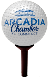 Golf ball on a brown tee with the Arcadia Chamber logo on it.