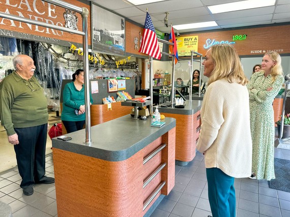 a woman standing in front of a retail store counter 