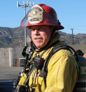 a firefighter in front of mountains 