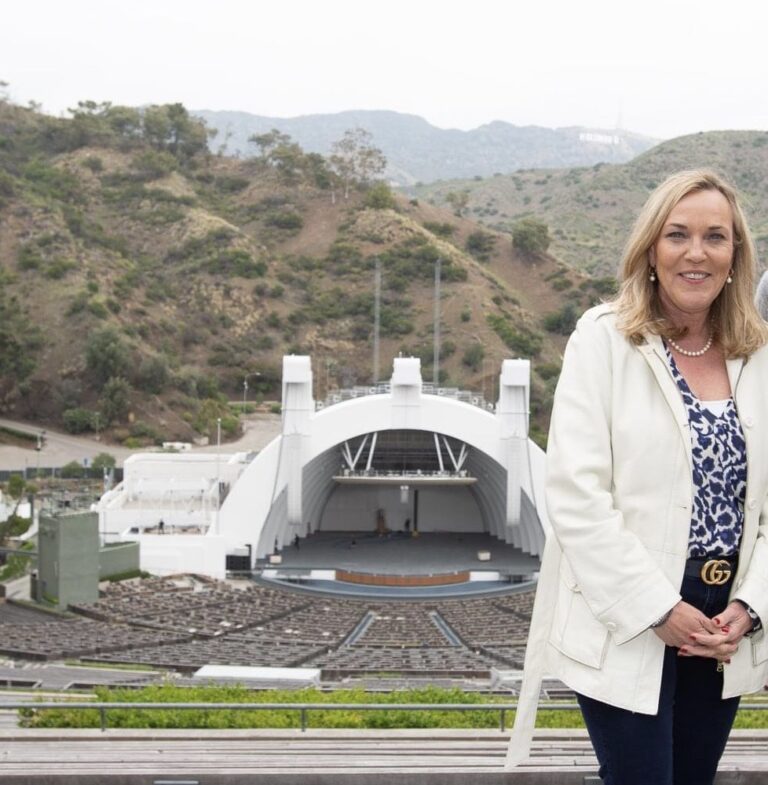 Supervisor Kathryn Barger stands above the Hollywood Bowl with the mountains and Hollywood Sign behind her