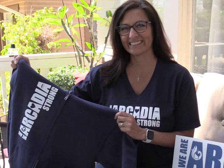 Karen Mac Nair, CEO of the Arcadia Chamber of Commerce, holding a Arcadia Strong sweatshirt.