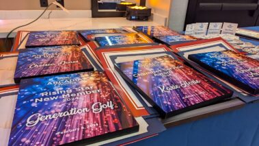 a grouping of colorful plaques with names on them set up on a table with a blue cloth