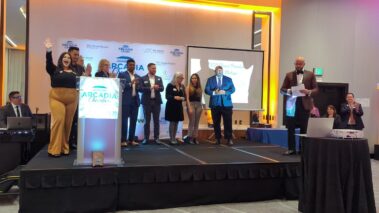 a group of people on a stage clapping