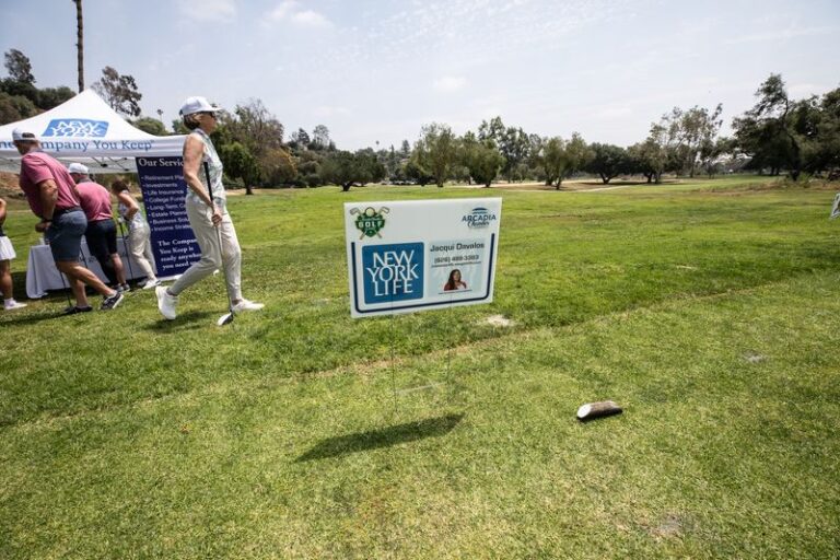 a tee sign for New York Life set up beside a booth with the same logo on it