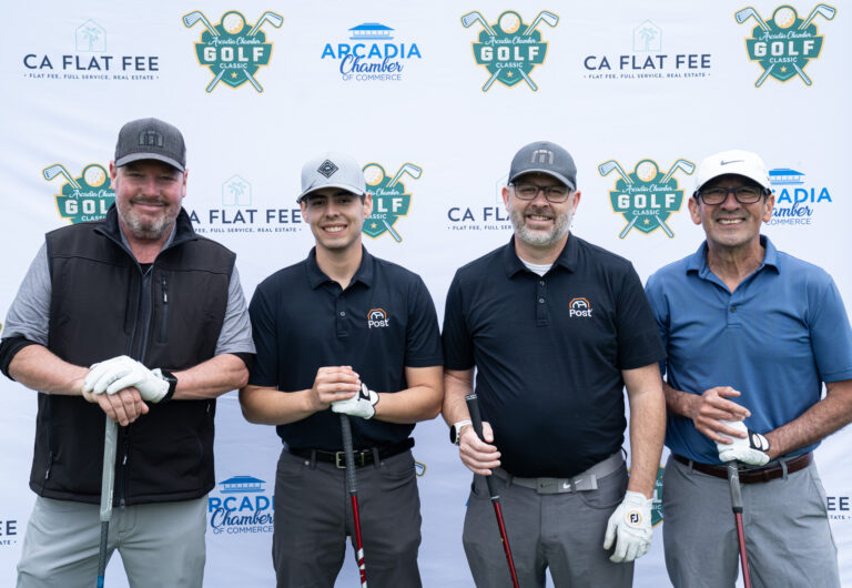 a group of four golfers from the Post Alarm team