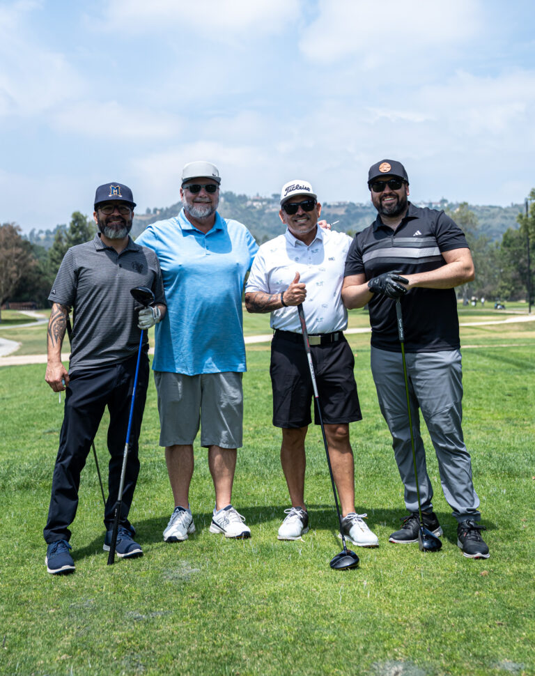 a group of four golfers from the Neil Bradley Team