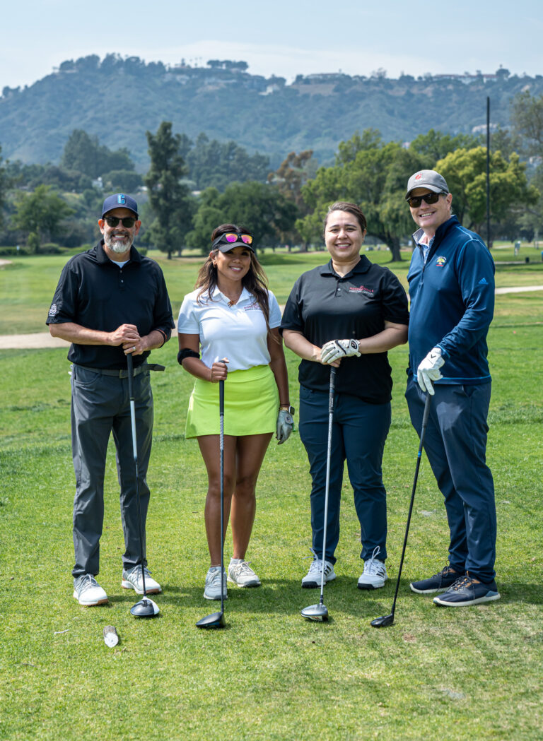 a group of four golfers from Rose Hills