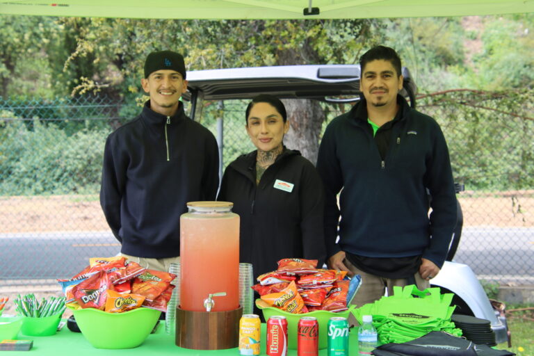 the team at Servpro posing behind a table of snacks and drinks