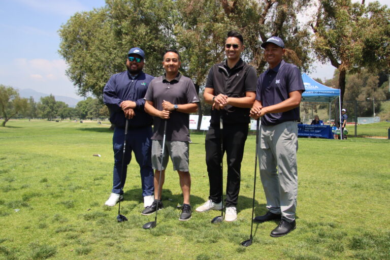 a group of four men posing with golf clubs, from the Arcadia 3 Par Golf Course