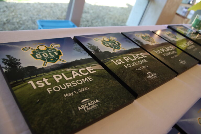 a row of awards for 1st place for a foursome at the Arcadia Chamber golf classic