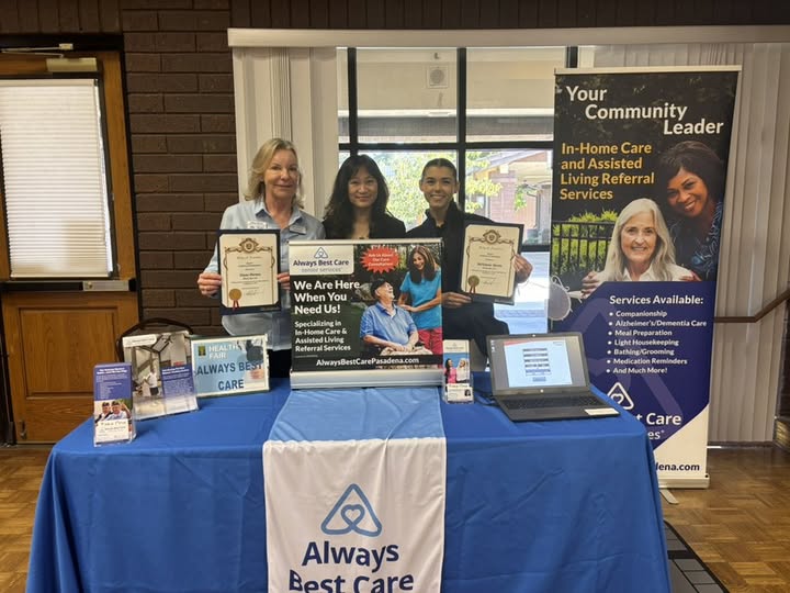a woman and a man stand beside the mayor of arcadia, holding certificates, at a health fair