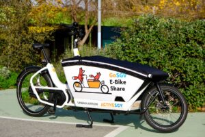 an electric cargo bike parked on the sidewalk 