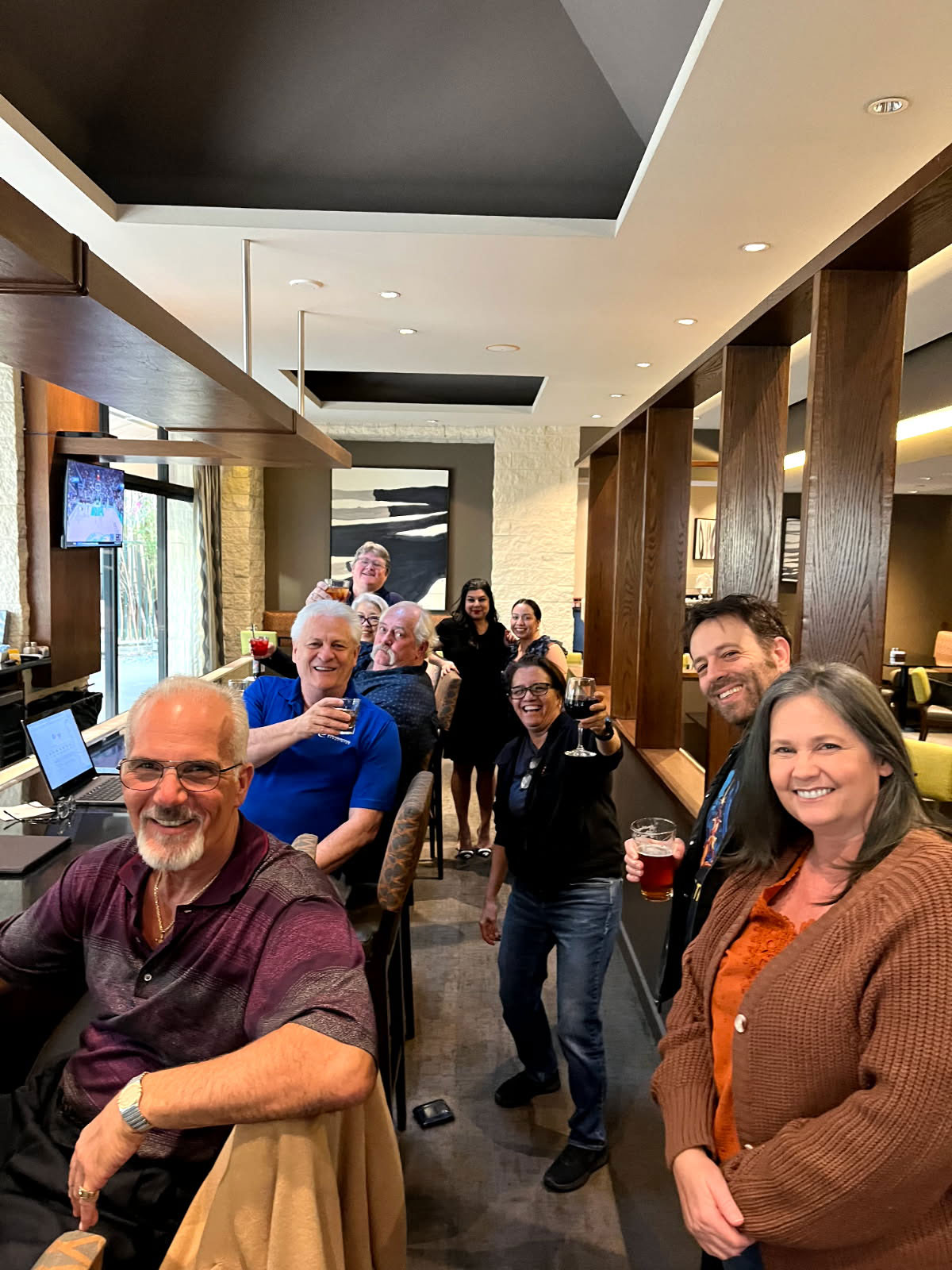 a group of people sitting in a cafe all looking at the camera