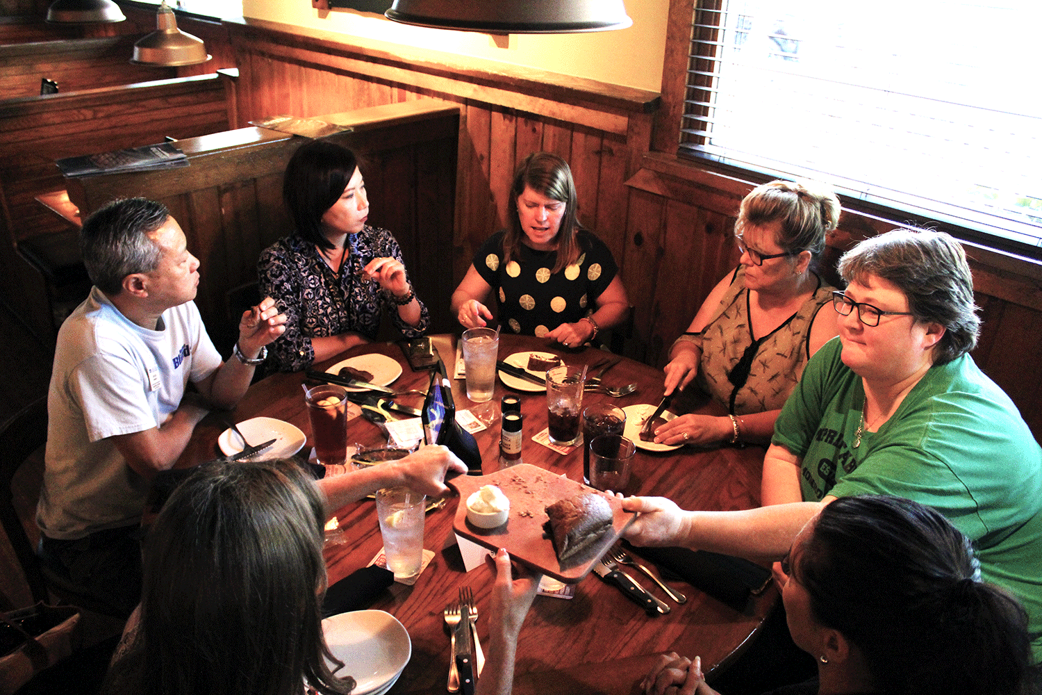 a group of people eating lunch at a round table