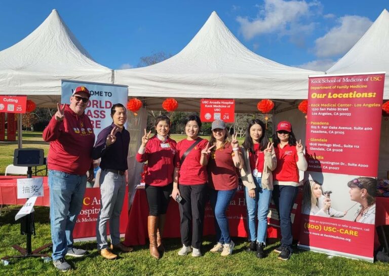 a group of team members from USC Arcadia Hospital in front of white tents