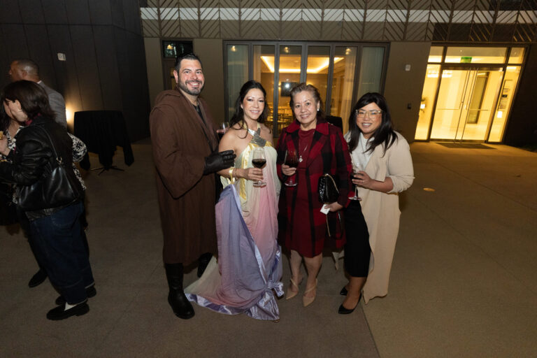 a group of three women in various star wars costumes with a tall man in a brown cloak