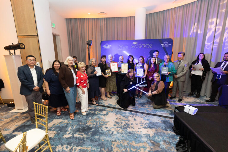 a group of people in various star wars outfits and suits standing in front of a backdrop