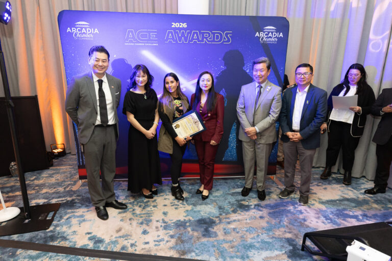 a group of people in various star wars outfits and suits standing in front of a backdrop