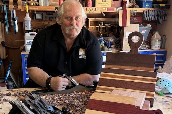 David Lamb in his workshop showing off cutting boards