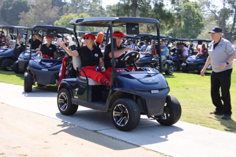 Fred's Monrovia golfers in a golf cart