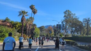people running down the street with mountains in the background