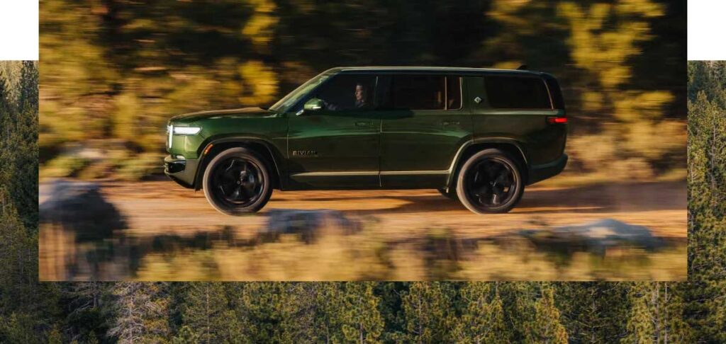 a Rivian SUV in the forest