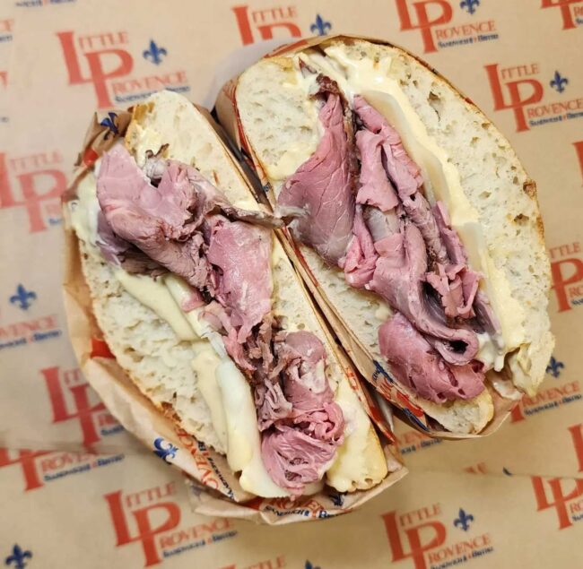 a pastrami sandwich from Little Provence on paper stamped with their logo