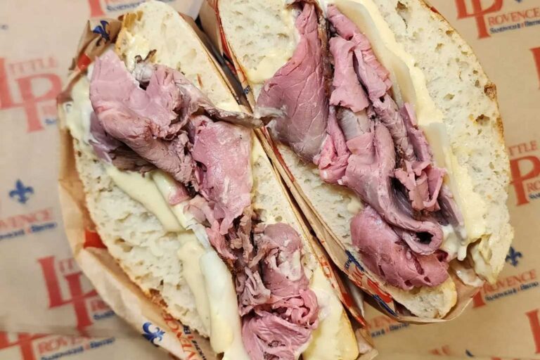 a pastrami sandwich from Little Provence on paper stamped with their logo