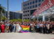 a group of people holding a pride flag