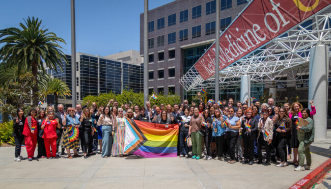 a group of people holding a pride flag